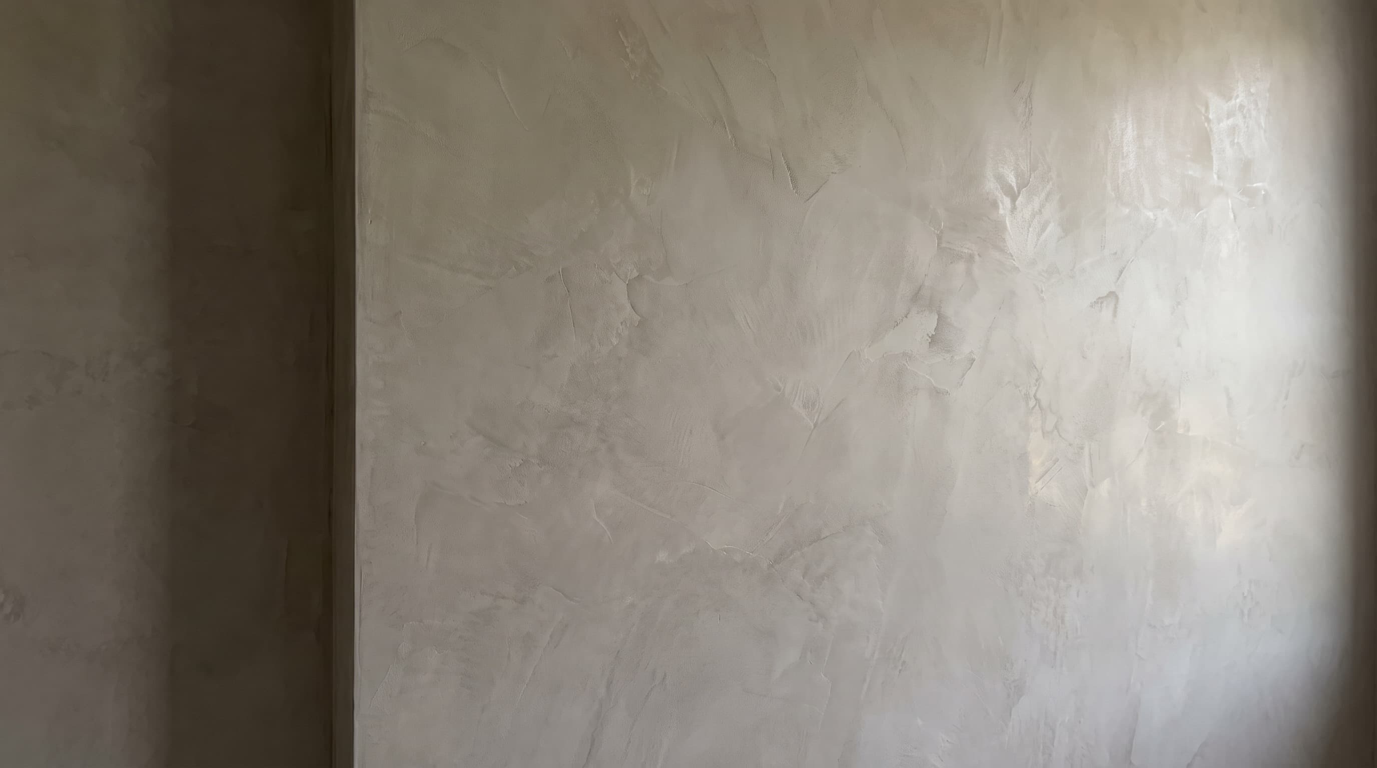 A burnished plaster wall in soft raking light