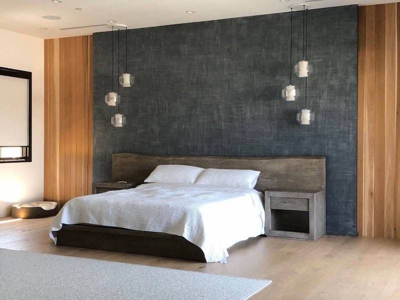 A bedroom wall in Meoded Sapphire Metallic, Sahara Effect, a dark textured shimmer between wood panels
